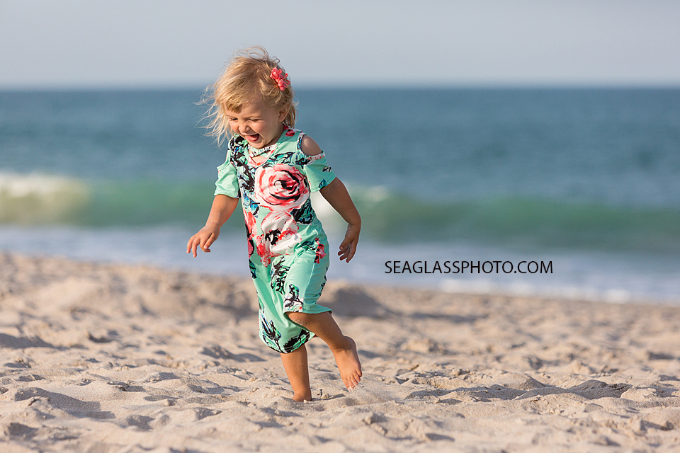 Close up of young girl running on the beach during family photos in Vero Beach Florida