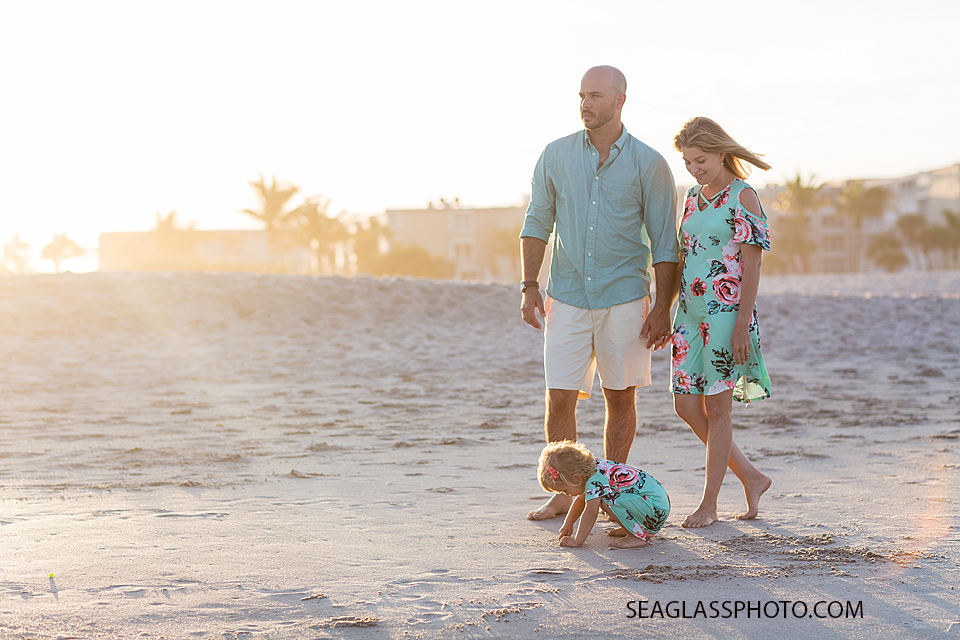 Family walking on the beach at sunset during family photos in Vero Beach Florida