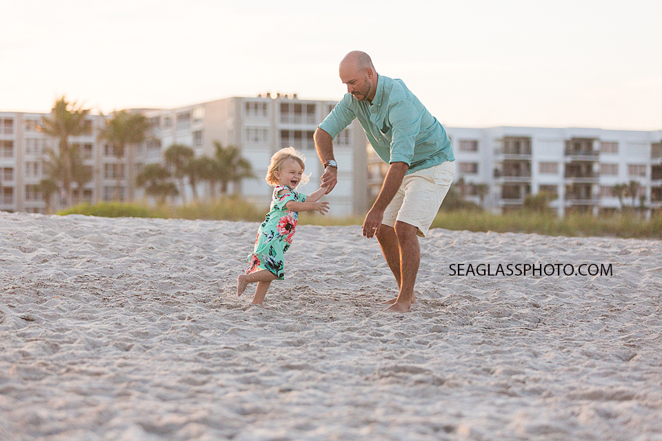 Dad playing with daughter at the beach during Family Photos in Vero Beach Florida
