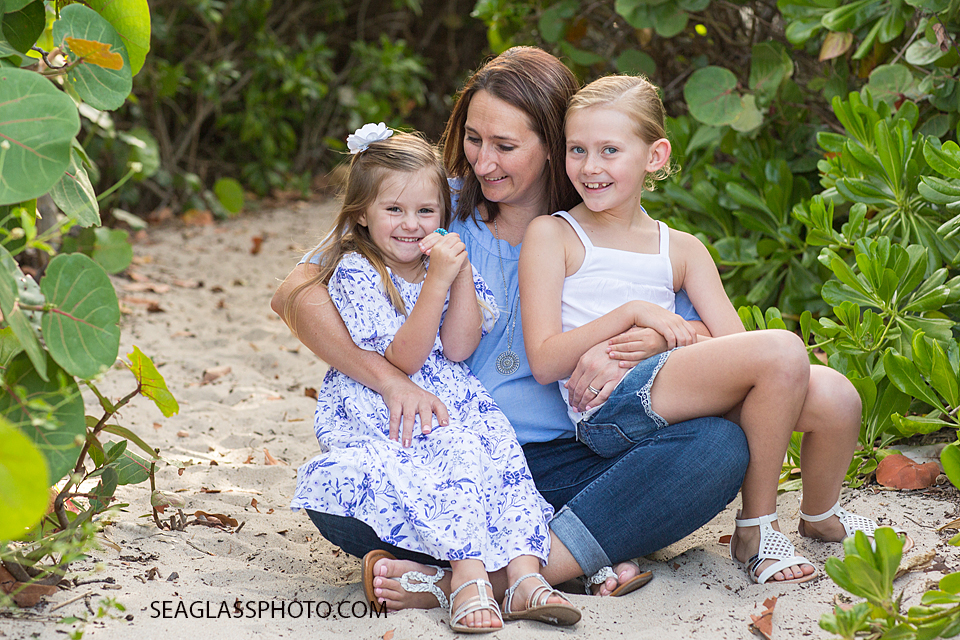 Mom and her daughters sitting in front of sea grapes in Vero Beach Florida by Seaglass Photography