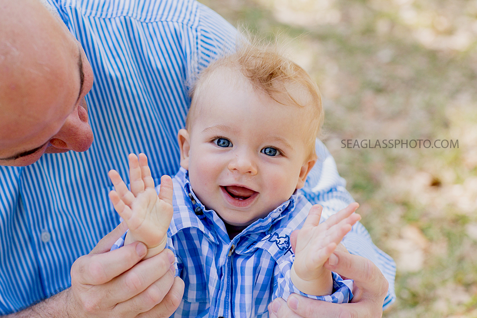 Close up of the dad holding his son at Riverside Park during family photos in Vero Beach Florda