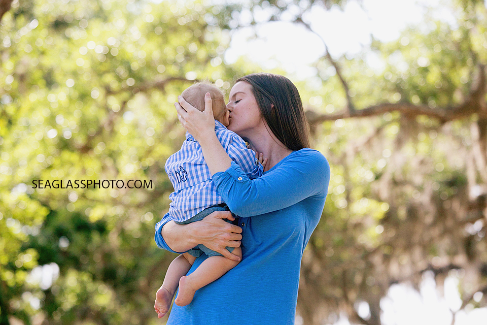 Mom kissing her son on the cheek at Riverside park in Vero Beach Florida