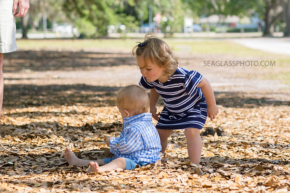 Big sister goes in for a kiss on her brothers head at Riverside Park in Vero Beach Florida