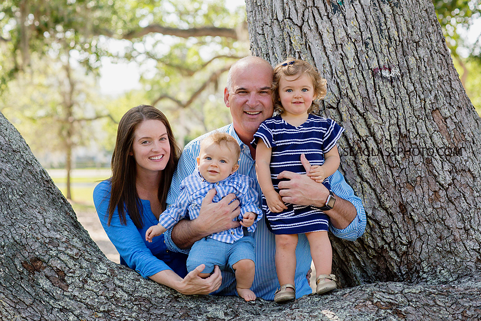 Family posing in the trees during family photo shoot at Riverside Park in Vero Beach Florida