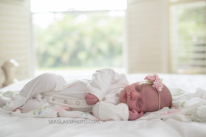 Newborn girl sleeps peacefully during newborn shoot in Vero Beach Florida