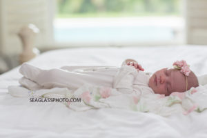 Newborn baby girl sleeps during her newborn shoot in Vero Beach Florida