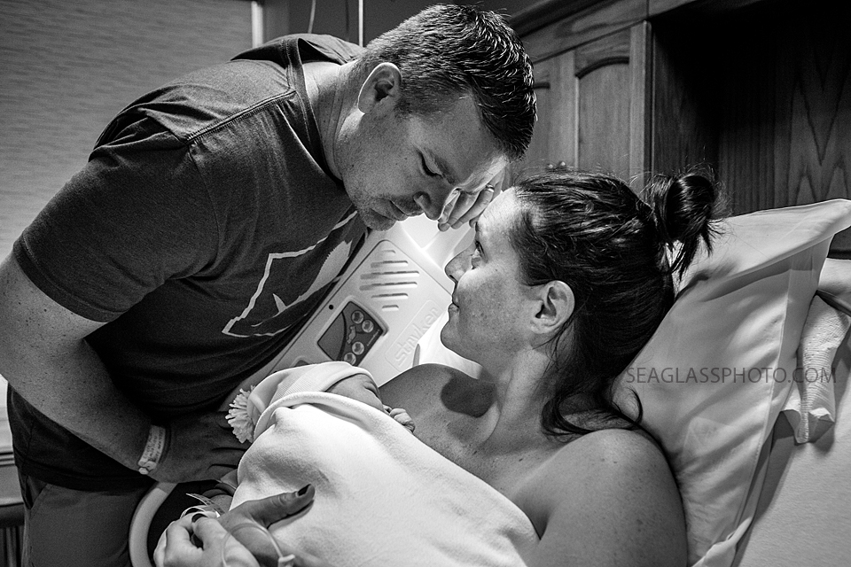 Mom and Father admiring their new daughter after being born at indian River Hospital in Vero Beach Florida