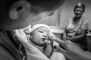 Close up of Father holding his new daughter in the Indian River Hospital in Vero Beach Florida