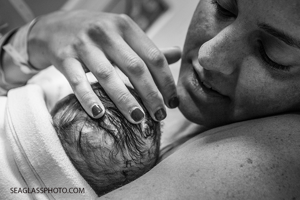 Close up of mom holding her daughter after birth in Vero Beach Florida