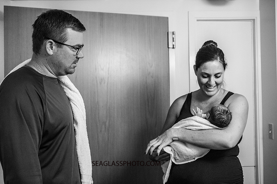 Mom and dad look at their baby girl after he first bath in Vero Beach Florida