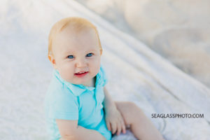 Close up of young boy sitting on the beach during family photos in Vero Beach Florida