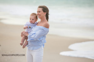 Mom holds her son on the beach at Johns island beach club during family photos in Vero Beach Florida