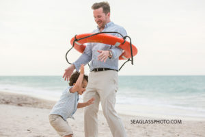 Uncle messing with his nephew on the beach at John island beach club during family photos in Vero Beach Florida