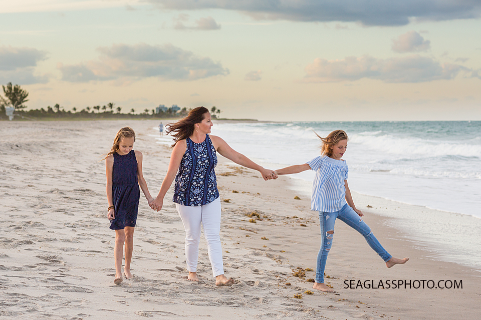 Mother and daughters walking on the beach during family photos in Vero Beach florida