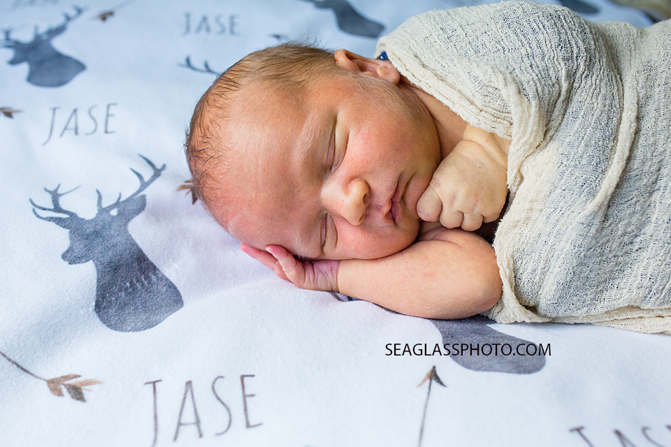 Close up of newborn baby boy sleeping on his side during newborn session in Vero Beach Florida