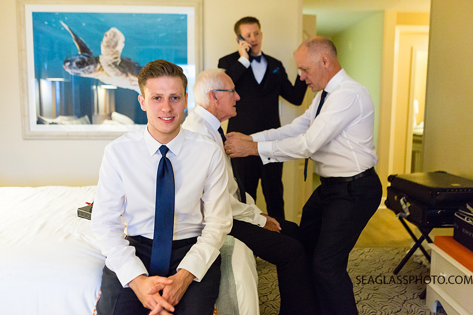 Groomsmen getting ready for the wedding wearing navy blue in Vero Beach Florida