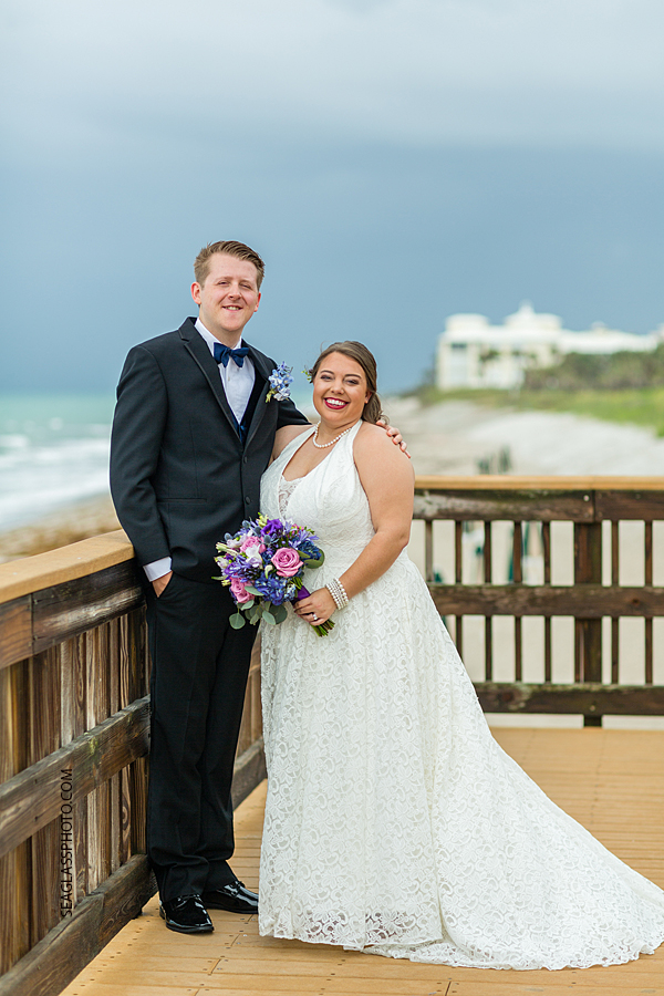Bride and groom pose together in front of the beach after saying i do in Vero Beach Florida