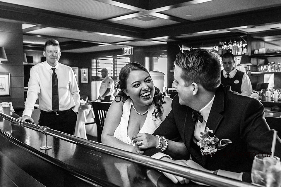 Black and white photo of husband and wife having a good time at their reception in Vero Beach Florida