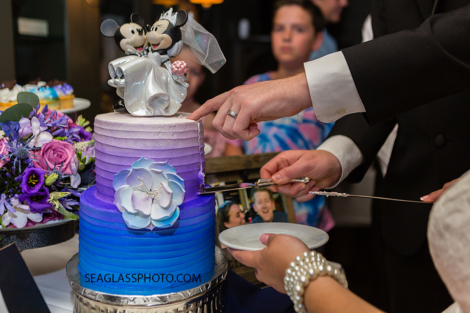 Bride and groom cut their wedding cake In Vero Beach Florida