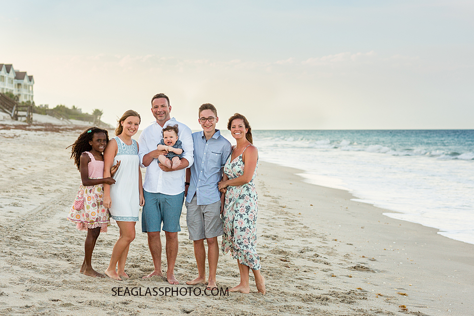 Famil poses on the beach during family photo shoot in Vero Beach Florida
