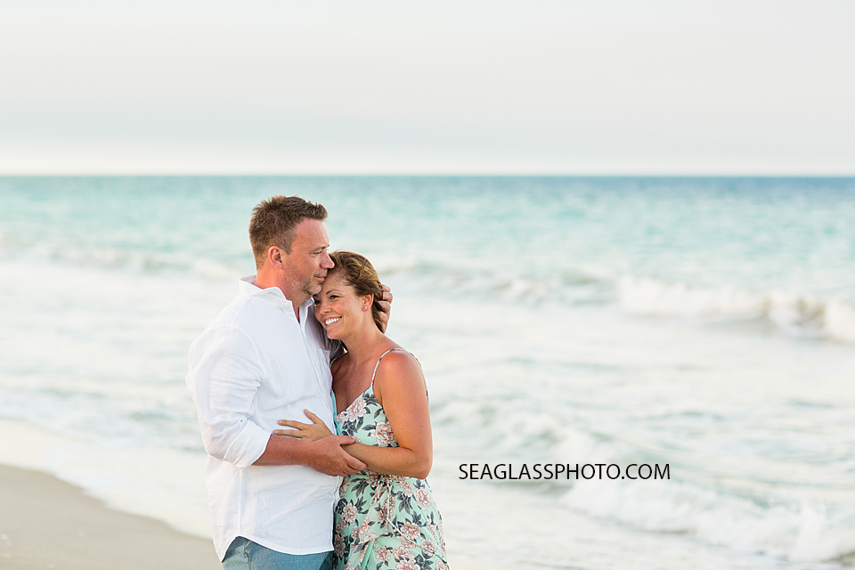 Mother and father hug on the beach during family photo shoot in Vero Beach Florida