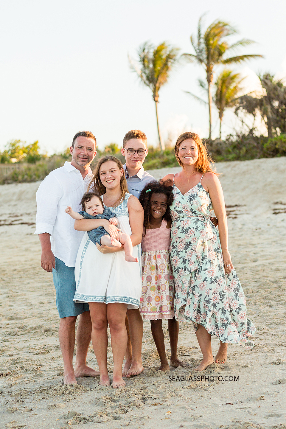 Family poses on the beach during family Photo shoot in Vero Beach Florida