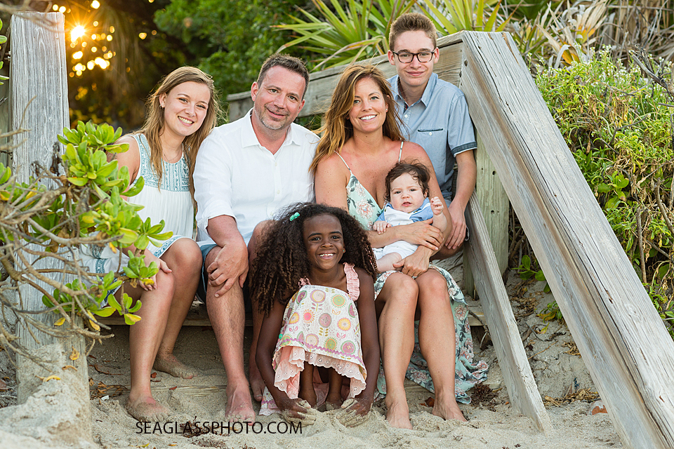 Family poses on the stairs at the beach during family photo shoot in Vero Beach Florida