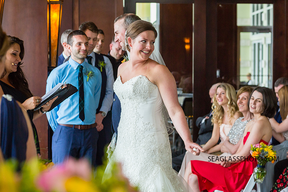 Bride looks back at her family smiling during the wedding at Kimpton Vero Beach hotel and spa in Vero beach Florida
