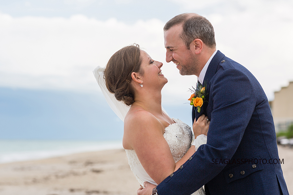 Close up of the newly wed couple smiling on the beach in Vero Beach Florida