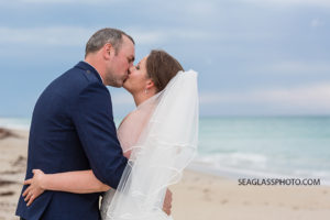Close up of the newly wed couple kissing on the beach in Vero Beach Florida