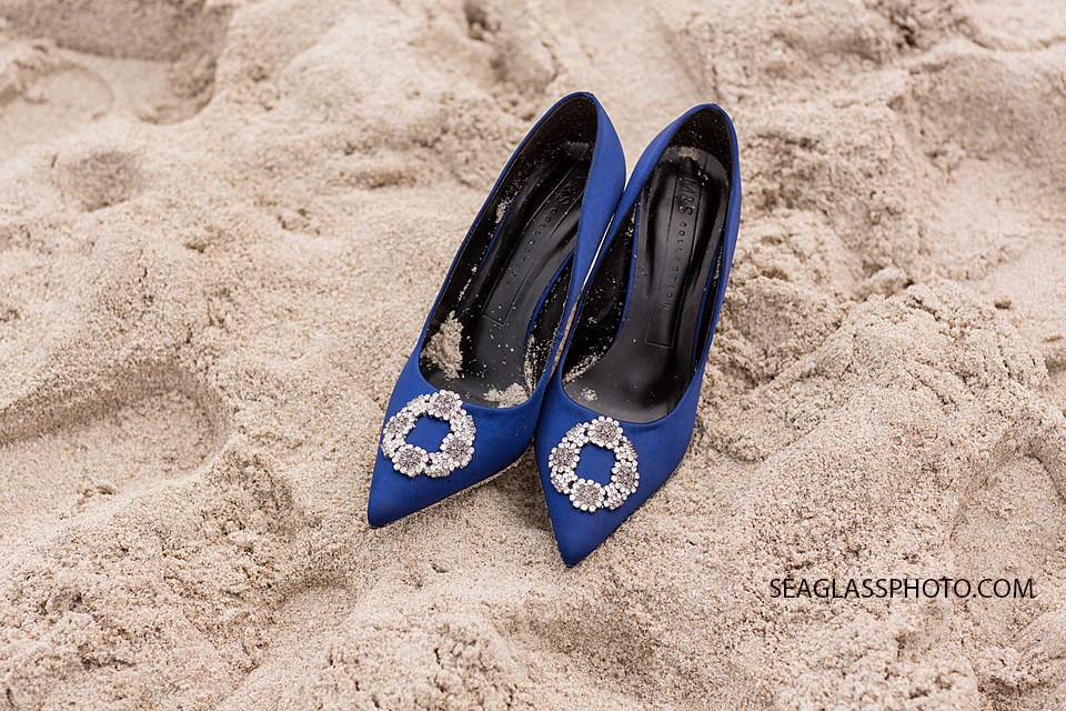 Close up of the Brides navy heels in the sand in Vero Beach Florida