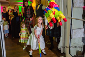 the flower girl hits a pinata for the first time ever at the reception at the Kimpton Vero Beach Hotel and Spa in Vero Beach Florida