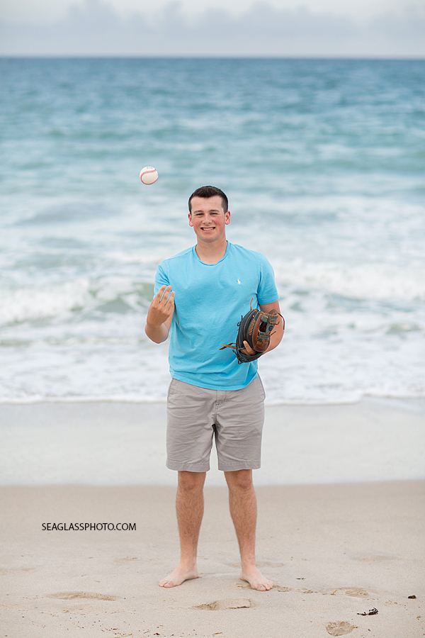 Soon to be senior varsity baseball player poses on the beach for his senior pictures in Vero Beach Florida