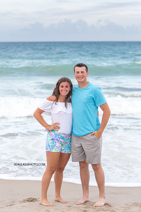 Brother and sister smile on the beach during family photos in Vero Beach Florida
