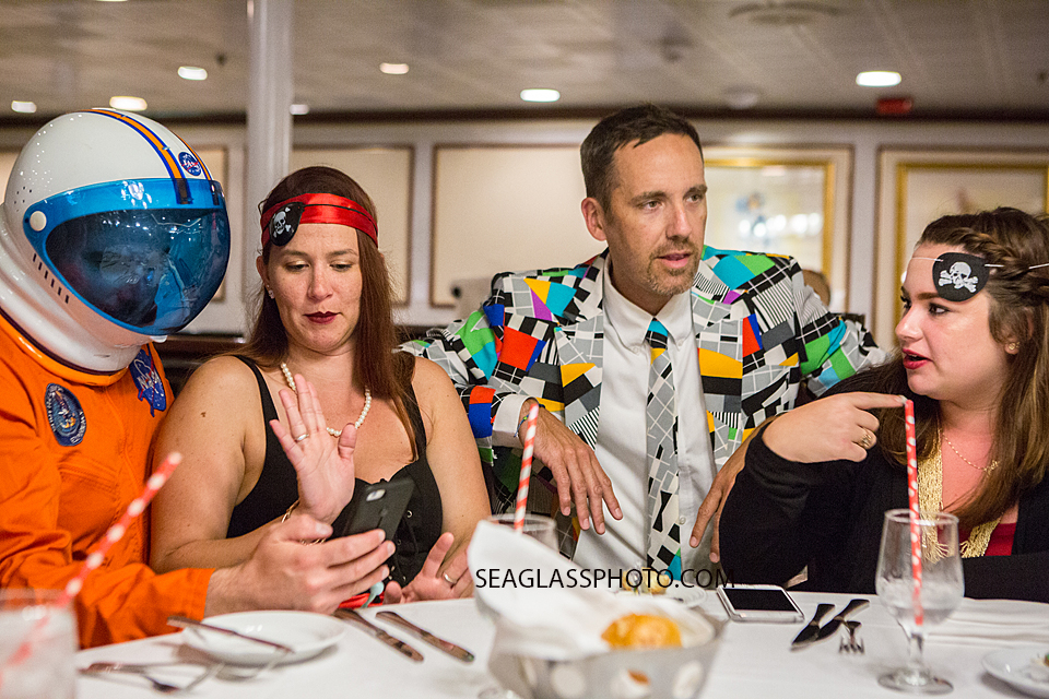 Family members sit at the table while on a cruise to the bahama's for a twenty first birthday party Photographed by a Vero Beach Florida Photographer