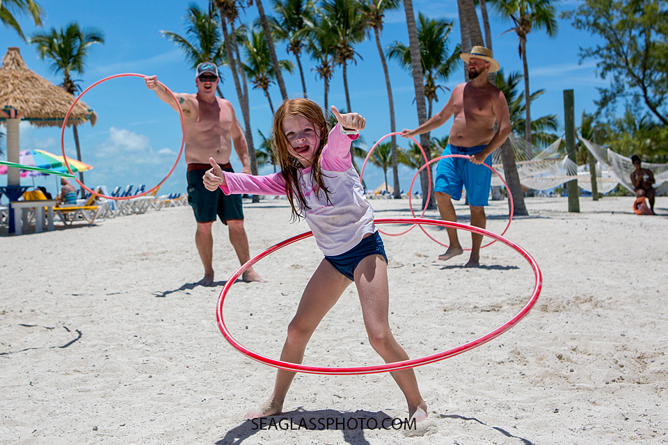 Young girl hula hoops on the beach in the bahama's Photographed by a Vero Beach Florida Photographer