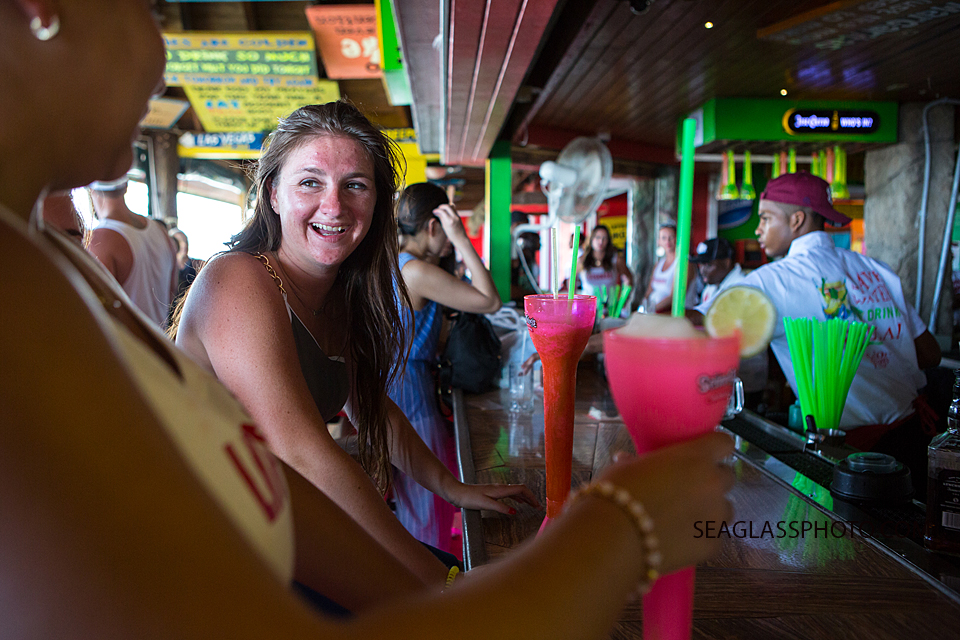 Young lady celebrates her twenty first birthday by ordering a drink at the bar in the bahama's Photographed by a Vero Beach Florida Photographer