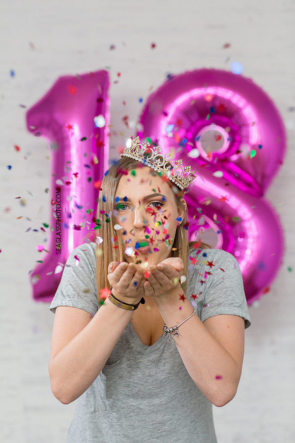 Young girl blows confetti for her eighteenth birthday in Vero Beach florida