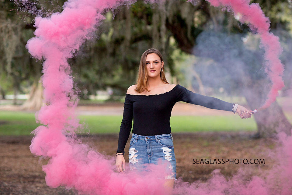 Pink ring of smoke surrounds her during her senior/ birthday photo shoot in Vero Beach Florida