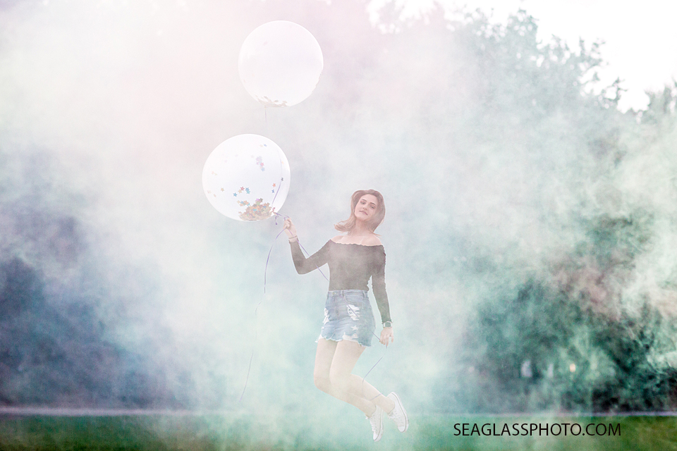 Young lady jumps during her senior/birthday shoot in Vero Beach Florida
