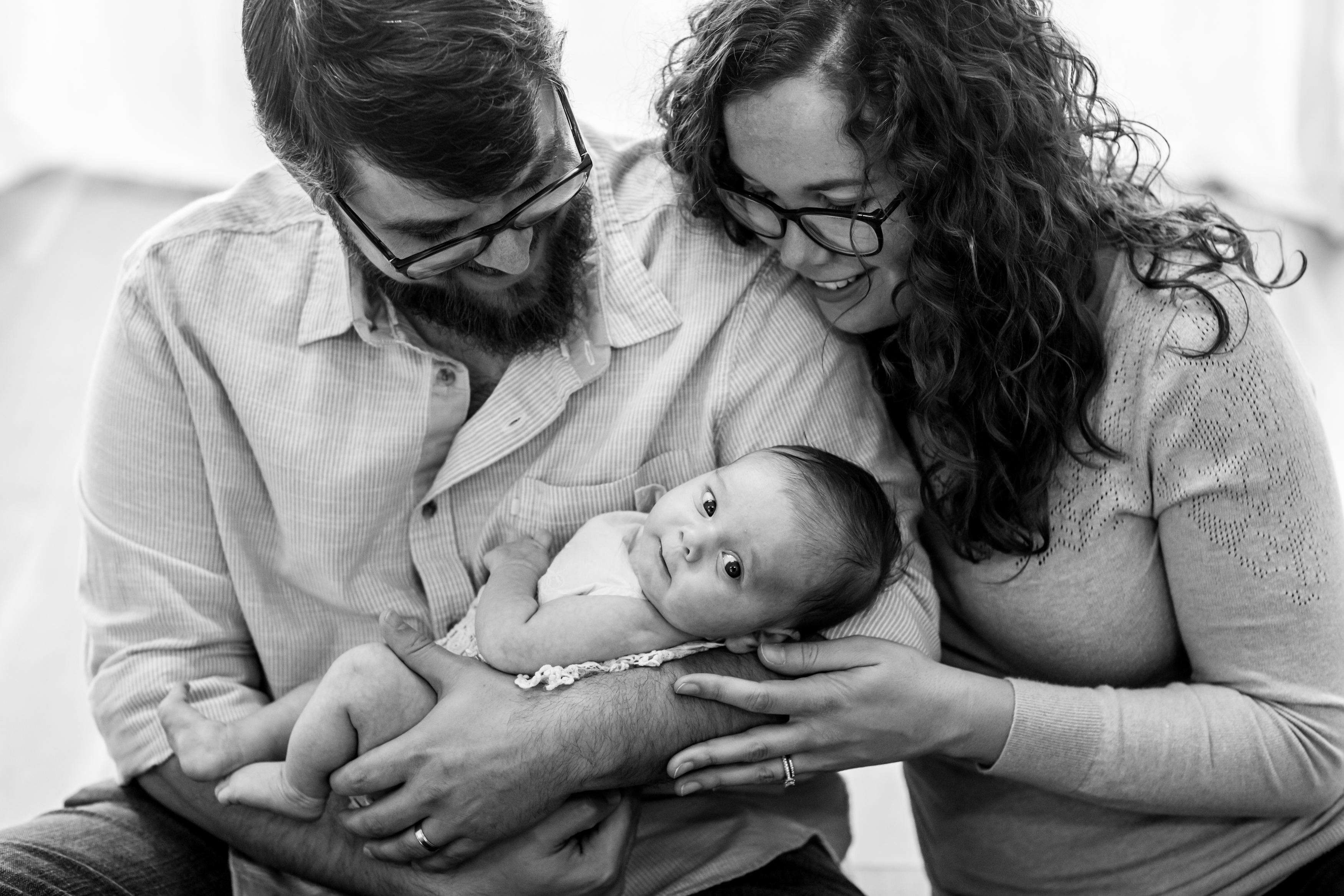 Black and white photo of parents holding their new born baby girl during new born session in Vero Beach Florida