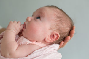 Close up photo of new born baby girl looking at her mom during new born session in Vero Beach Florida