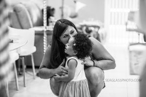 Black and white photo of a mom whispering to her daughter during a 90th birthday celebration in Vero Beach Florida