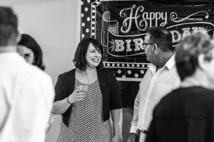 Black and white photo of guest smiling and mingle during a 90th birthday celebration in Vero Beach Florida