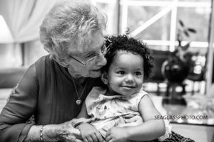 Black and white photo of grandma holding her granddaughter during her 90th birthday celebration in Vero Beach Florida