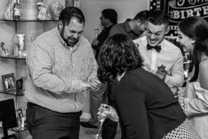 Black and white photo of guests having fun during a 90th birthday celebration in Vero Beach Florida