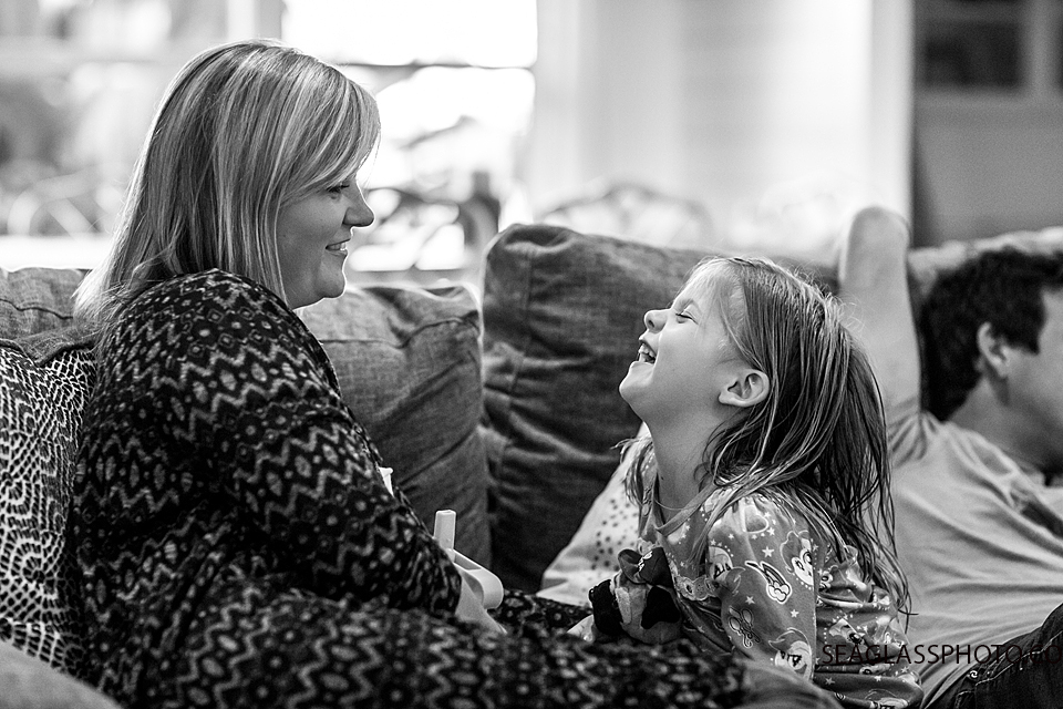 Black and white photo of mom and daughter laughing during a home photo shoot in Vero Beach Florida