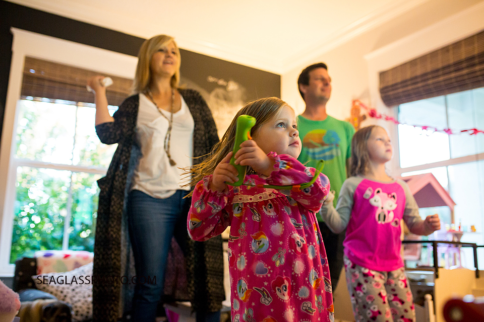 Family plays the wii during a home photo shoot in Vero Beach Florida