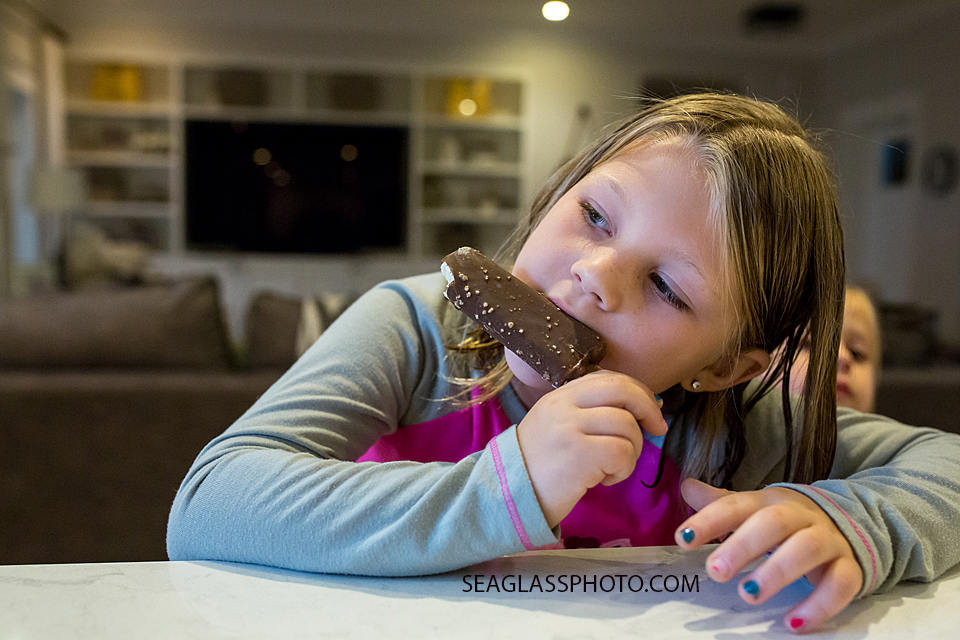 Young girl has ice cream before bed during a home photo shoot in Vero Beach Florida
