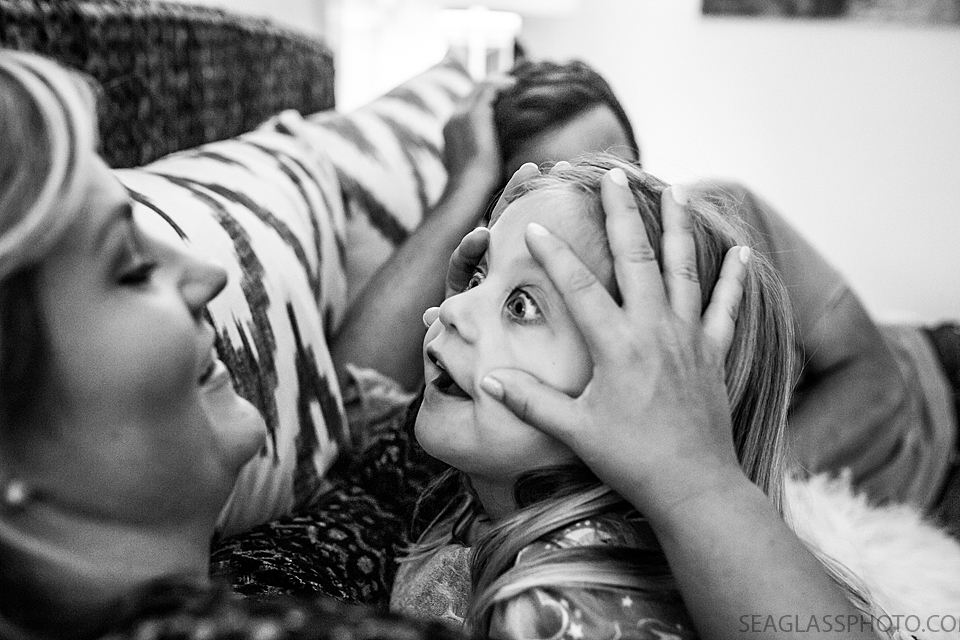 lack and white photo of mom messing around with her daughter before bed during a home photo shoot in Vero Beach Florida